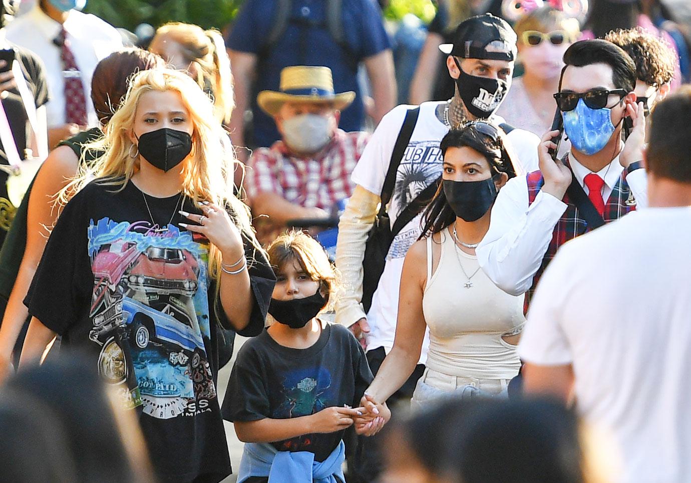 kourtney kardashian and travis barker take their modern family on a fun day out at disneyland