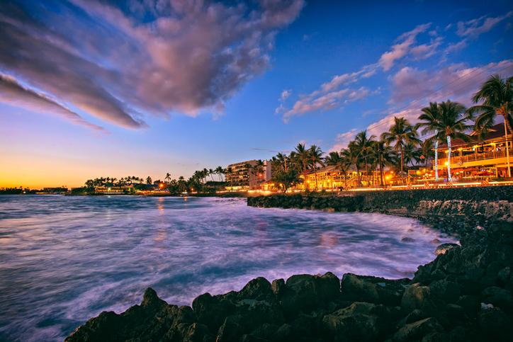 The sun sets along Alii Drive on the beach town of Kailua Kona on the Big Island of Hawaii.