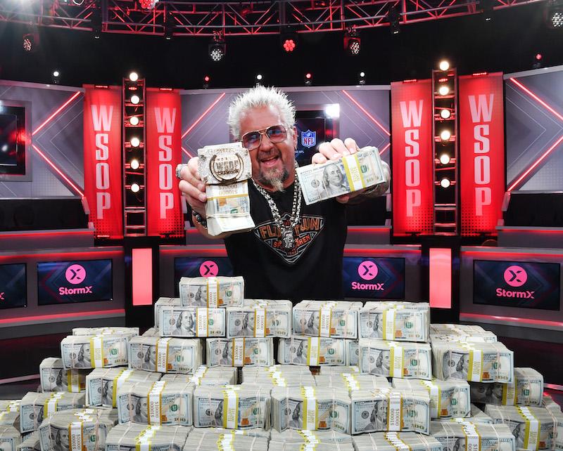 guy fieri poses with  world series of poker main event bracelet and stack of cash at horseshoe las vegas on july   in las vegas nevada photo by denise truscellogetty images for caesars entertainment