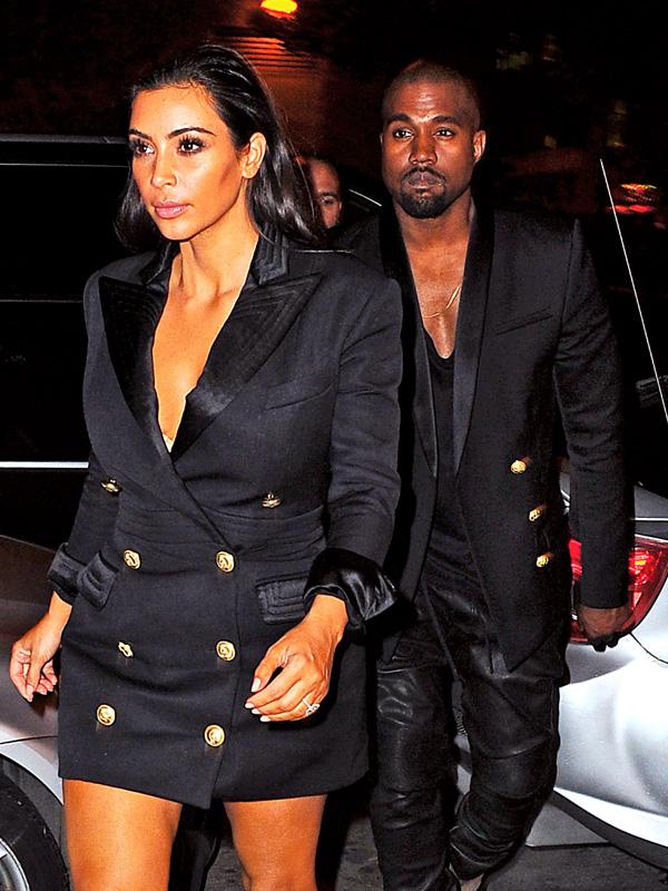 Kim Kardashian and Kanye West arrive back at their NYC in matching black blazers.