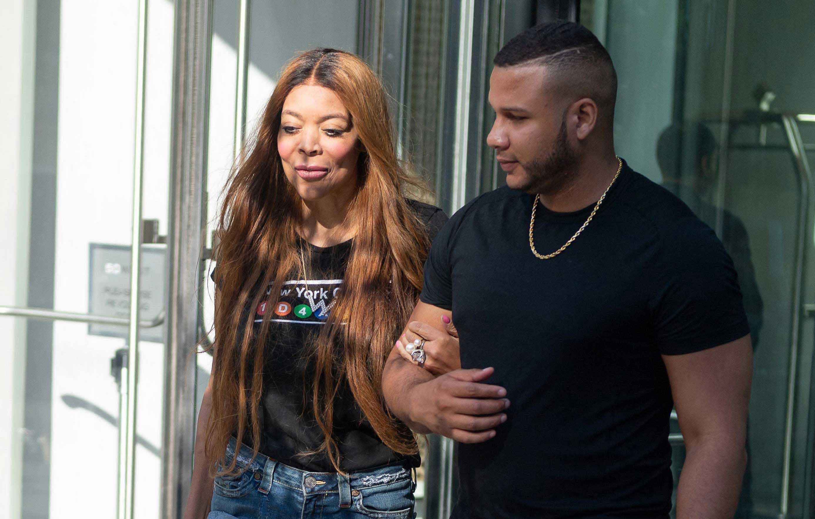 wendy williams carries wig hand mystery male companion