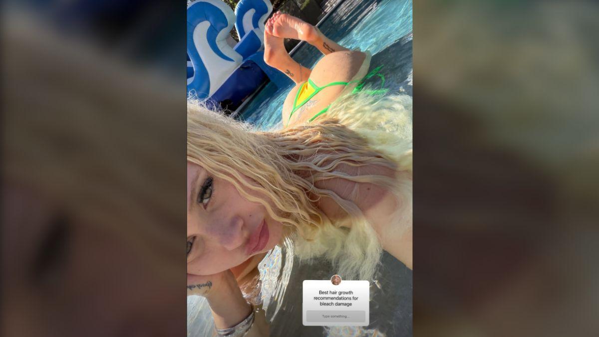 image of Barker shielded her face from the sun during a sultry selfie.