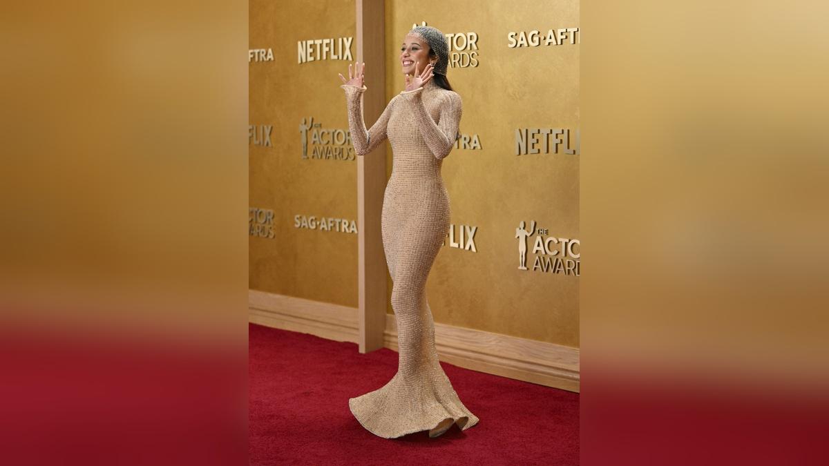 Image of Chase Infiniti flaunted her figure in a skintight nude dress.