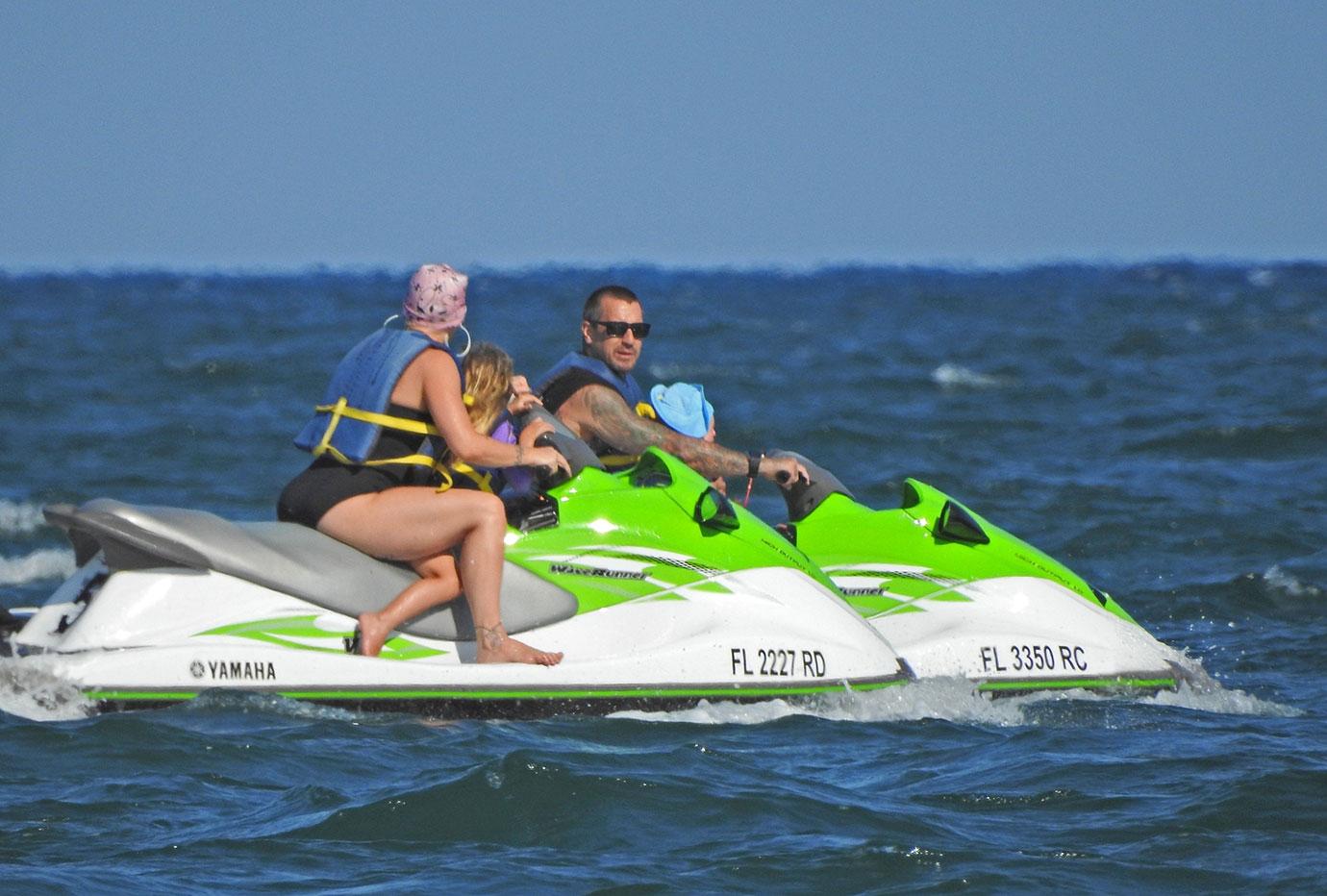 Pink and her adorable family ride some Jet Skis on the Beach in Florida