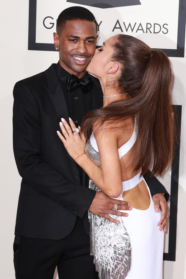 Singer Ariana Grande and rapper boyfriend Big Sean show lots of affection for each other and kiss and embrace on the red carpet at the 57th annual Grammy Awards