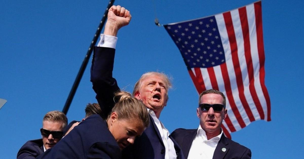 donald trump raises fist defiance shots fired rally