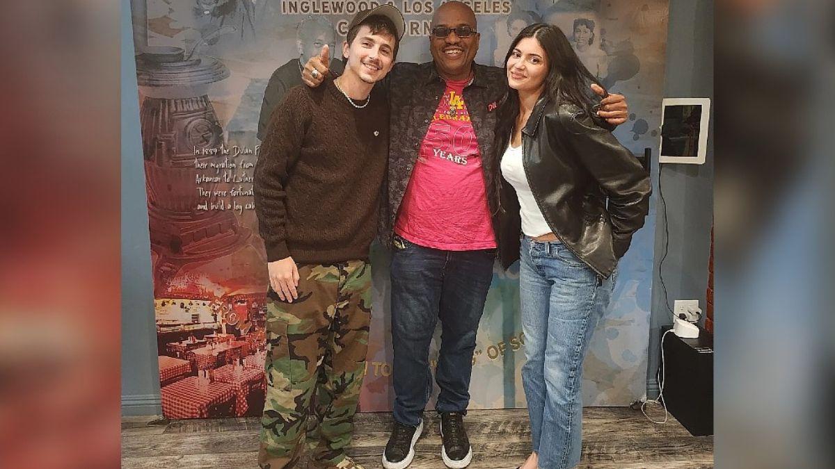 Photo of Timothée Chalamet and Kylie Jenner with a staffer from Dulan's Soul Food Kitchen