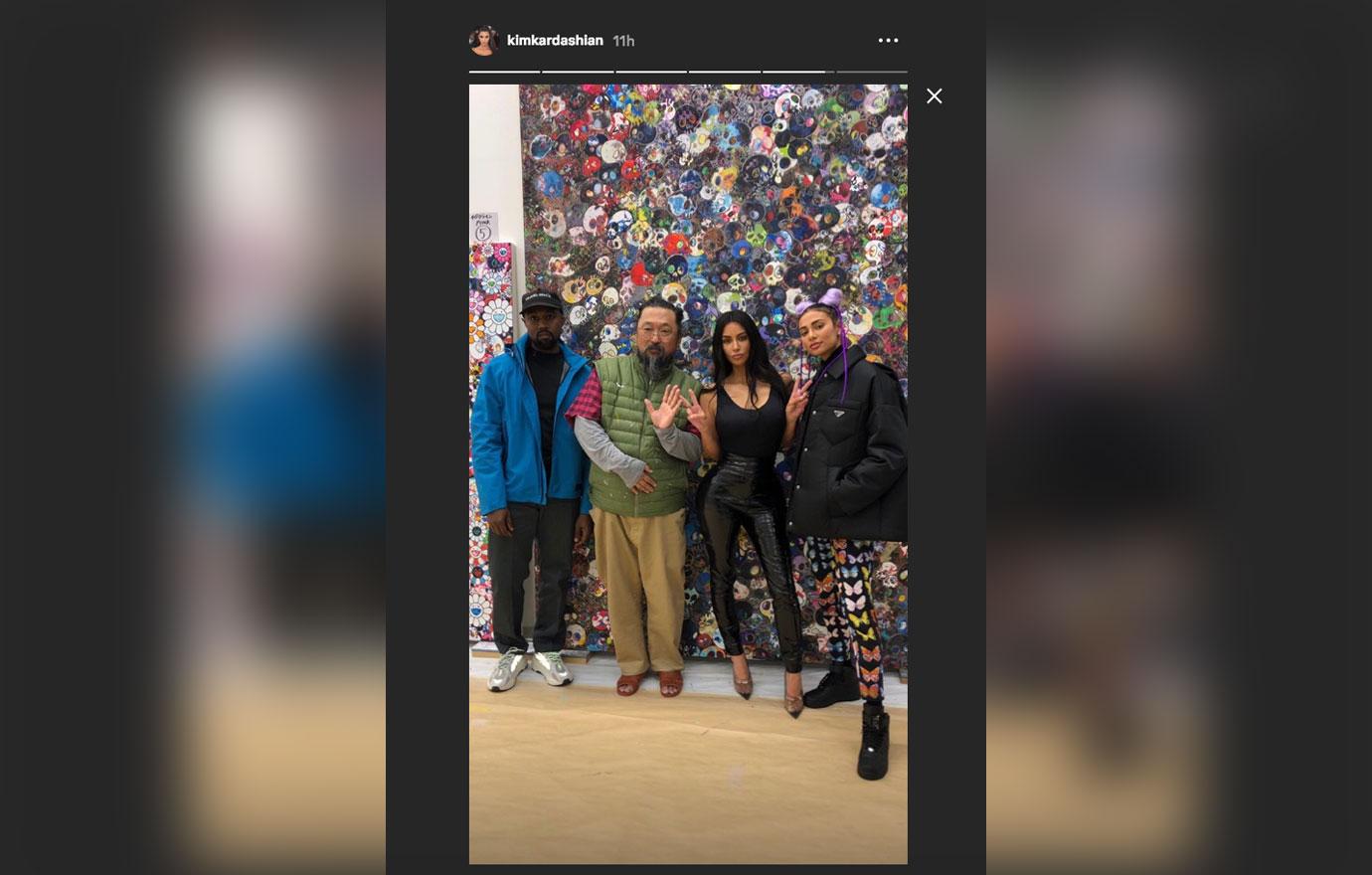 Kim Kardashian poses with Kanye West and artist Takashi Murakami in Tokyo