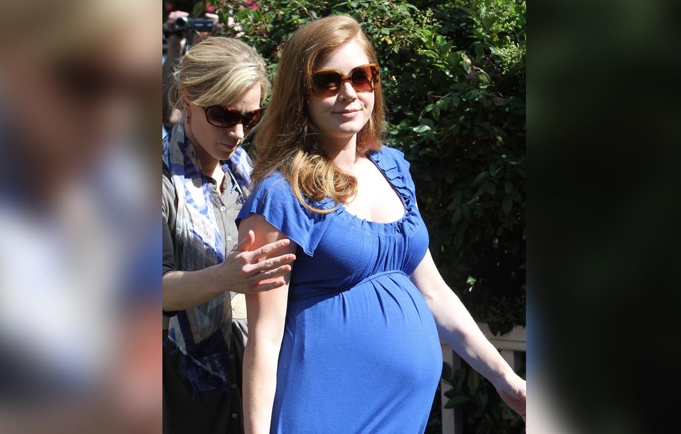 A heavily pregnant Jessica Alba in a blue dress at her baby shower.