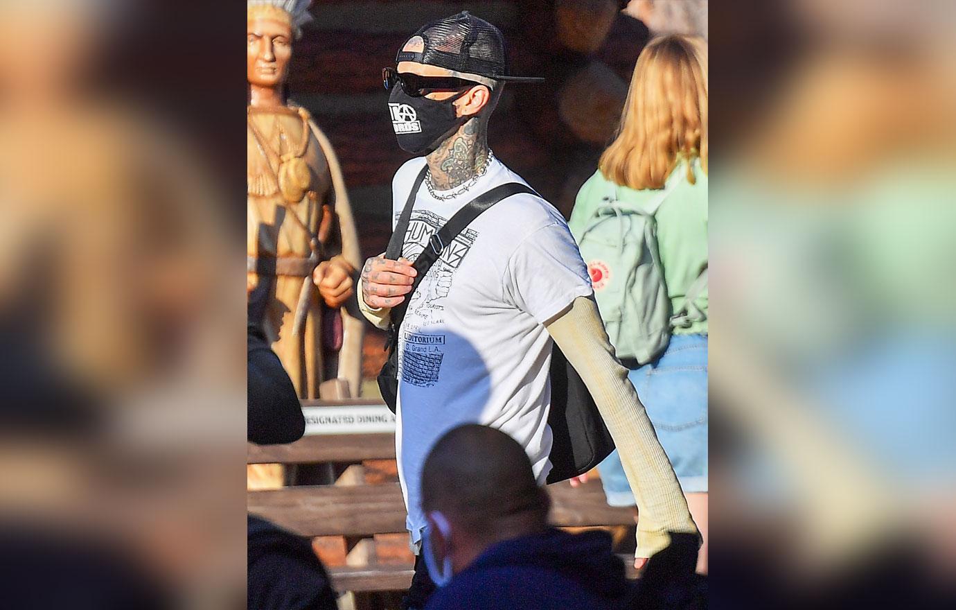 kourtney kardashian and travis barker take their modern family on a fun day out at disneyland