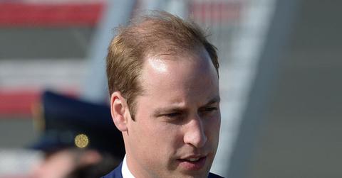 Prince william holding prince george