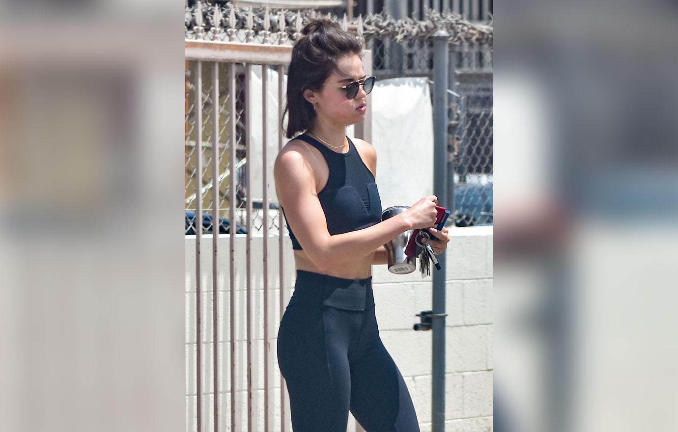 Lucy Hale displays her fit body in a sports bra and leggings as