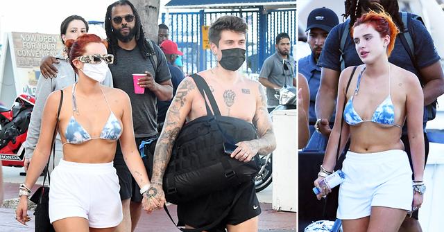 bella thorne wears a blue and white bikini as she holds hands with fiance benjamin mascolo while getting off a yacht