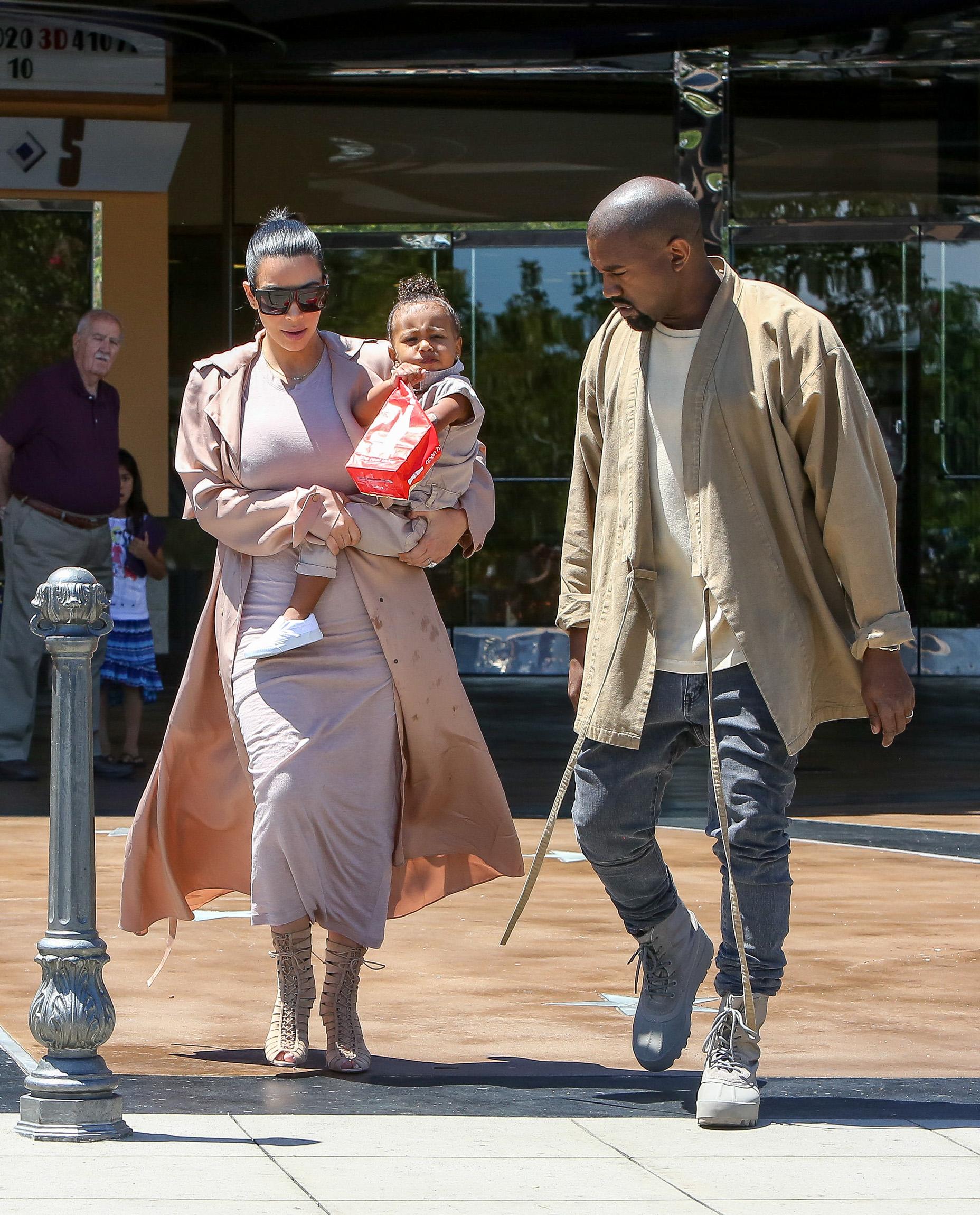 Kim Kardashian carries daughter North while going to the movies with Kanye West in Calabasas