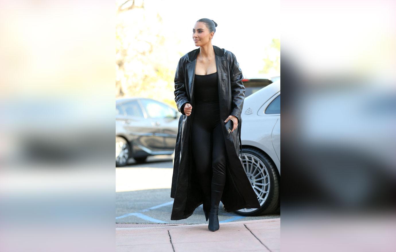 kim kardashian wears a long black leather jacket