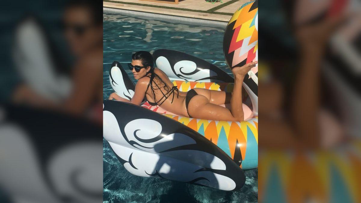 Image of Kourtney Kardashian exposed her butt on a pool floatie.