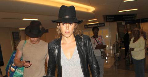 Nikki Reed and Ian Somerhalder wear matching hats as they arrive in Los Angeles with Reed's Service Dog