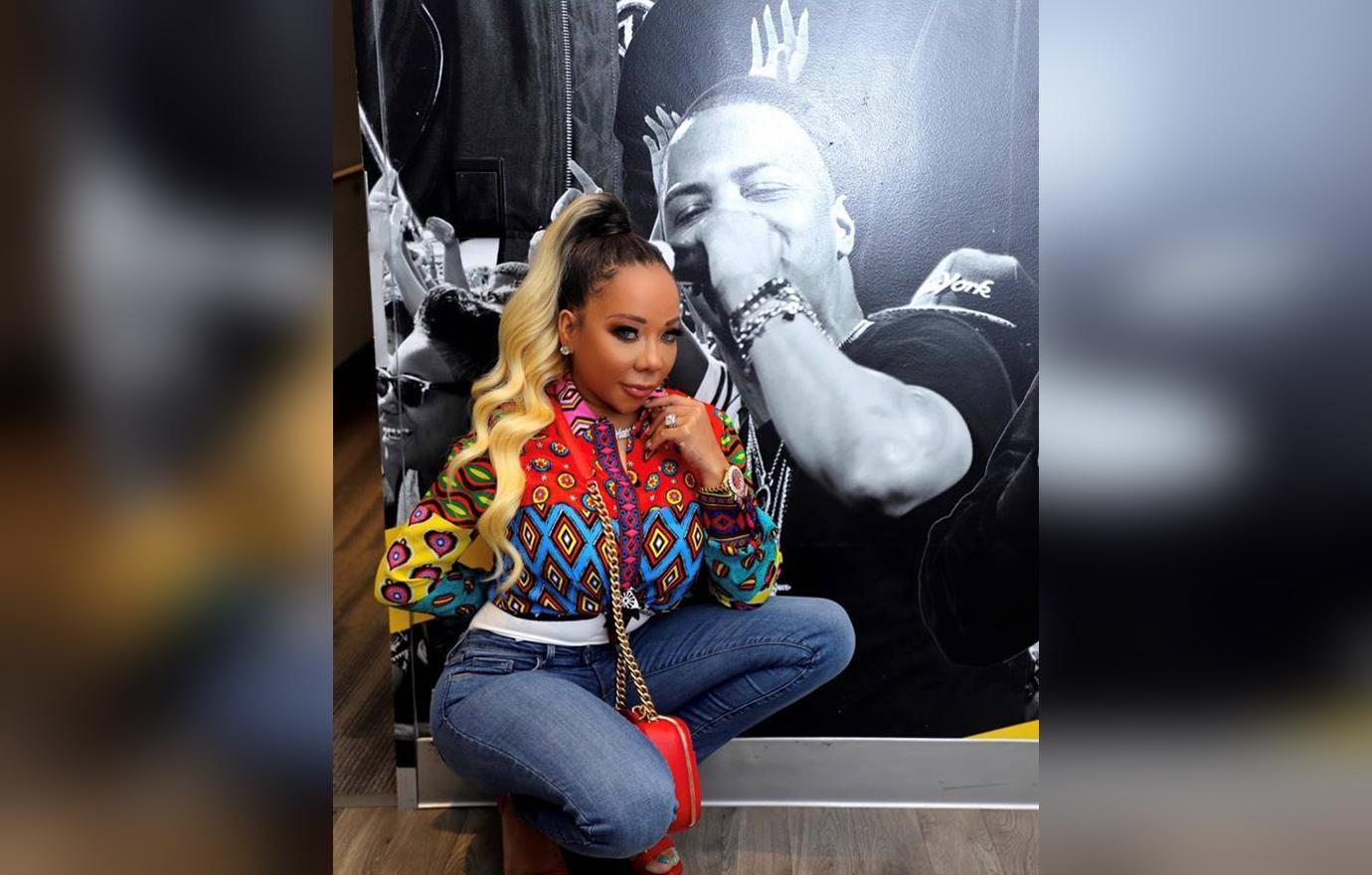 Tameka Tiny Harris Poses With Photo Husband TI