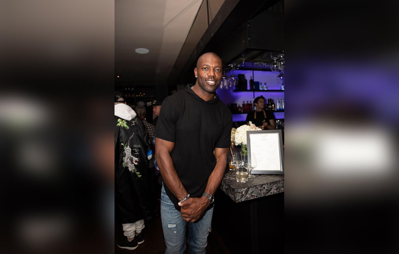 Terrell Owens In Black Shirt and Denim Jeans Smiling at Bar