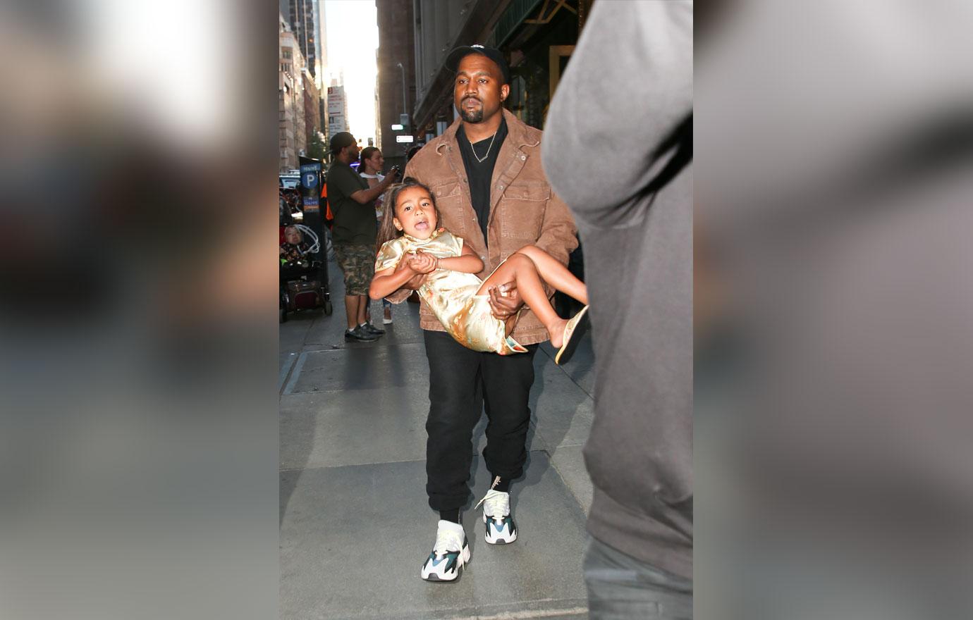 Kanye West seen carrying her daughter North West while leaving Polo Bar in NYC