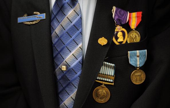 A veteran with war medallions on his jacket