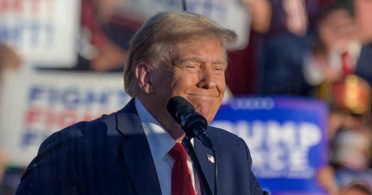 Photo of Donald Trump smiling at event.