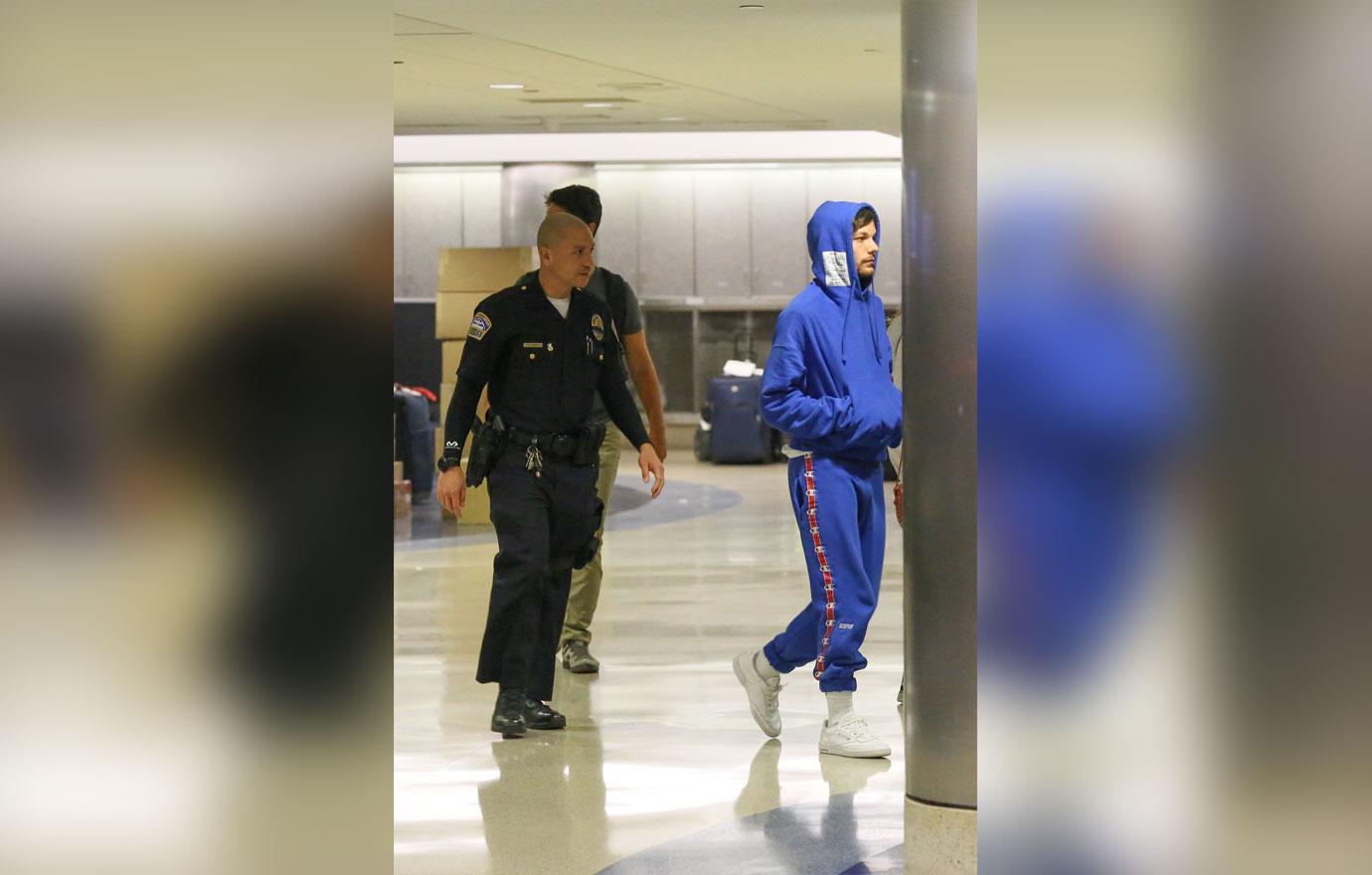 Louis Tomlinson airport arrest blue hoodie 05