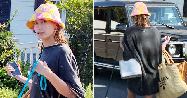 hailey bieber cools off in a tiny shirt dress sandals and a funky hat