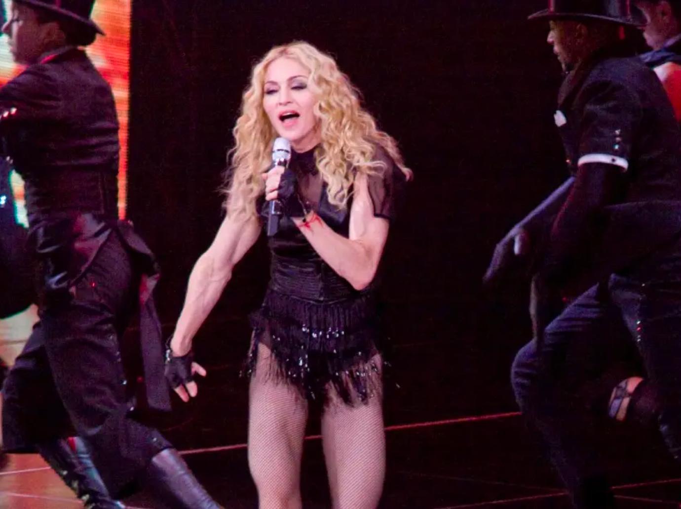 madonna walking nyc own merchandise rescheduling tour dates