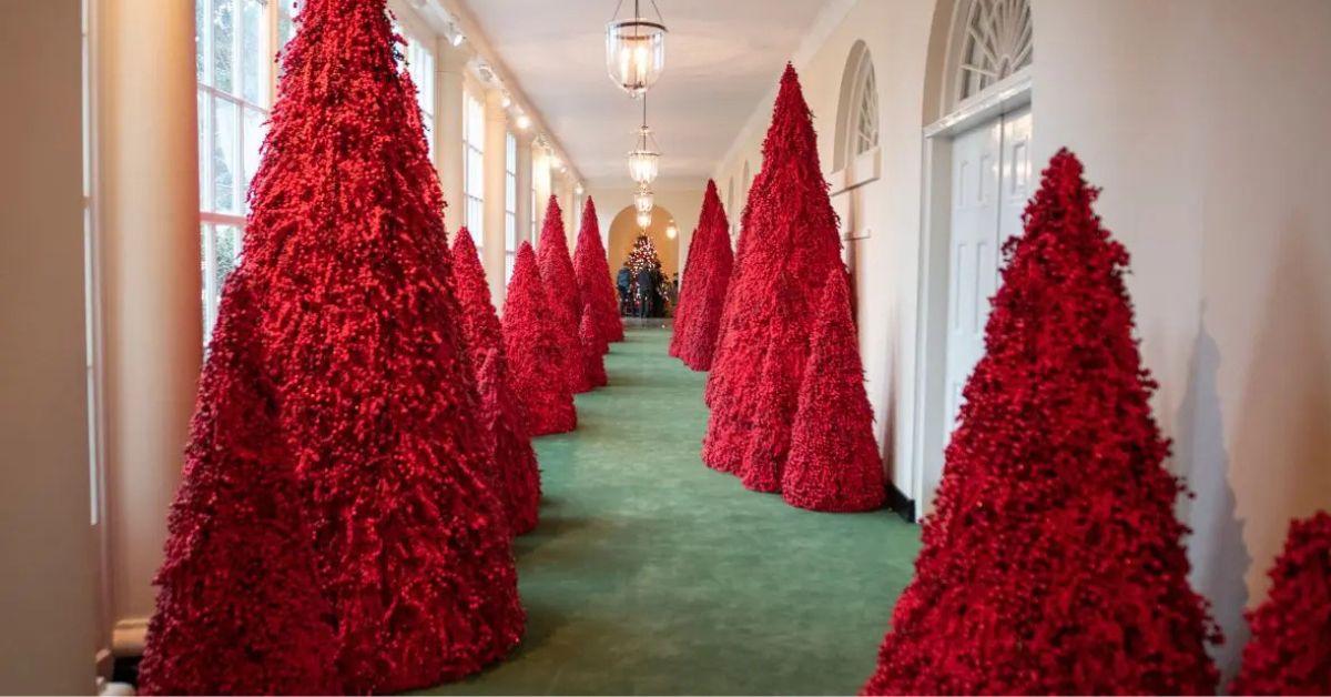 image of Melania Trump displayed red trees at the White House in 2018.