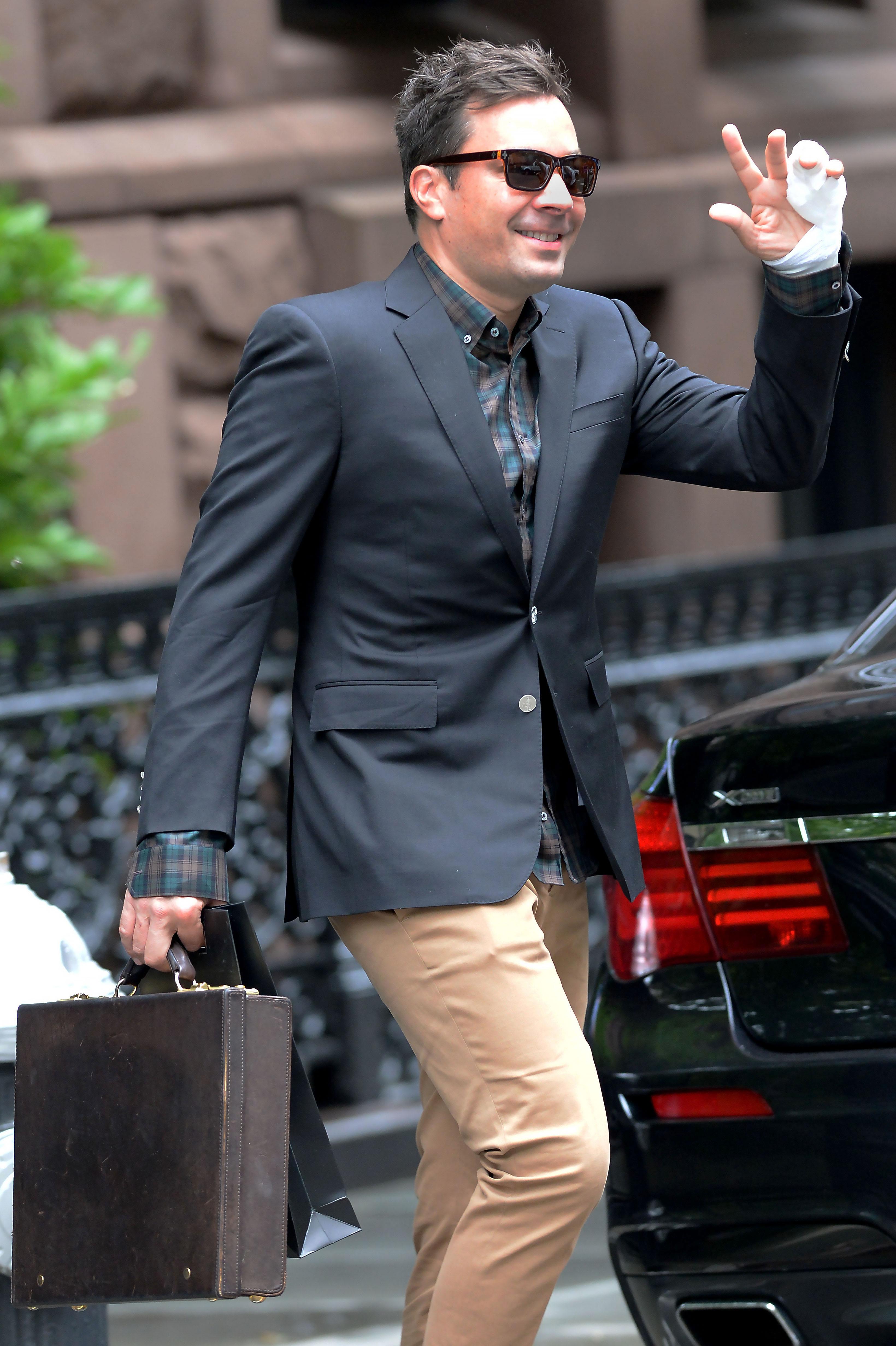 Jimmy Fallon departs his Manhattan residence with his injured hand while en route to work