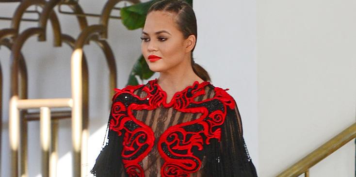 *EXCLUSIVE* Chrissy Teigen stuns in and red and black gown for a friend&#8217;s wedding