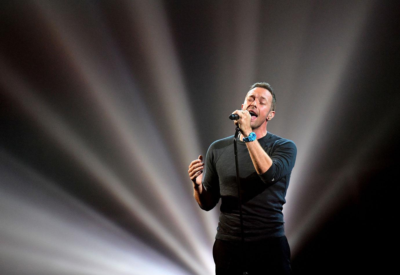 Chris martin performing with coldplay