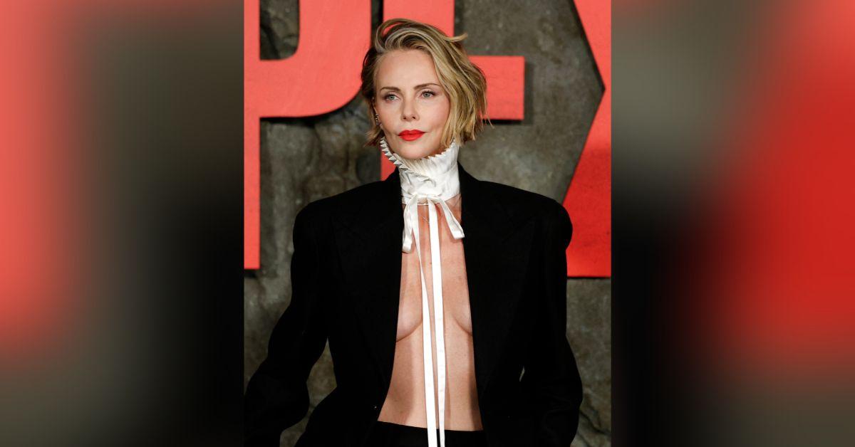 image of Charlize Theron made a bold statement by going topless under a sleek black suit at the NYC premiere of 'Apex.'