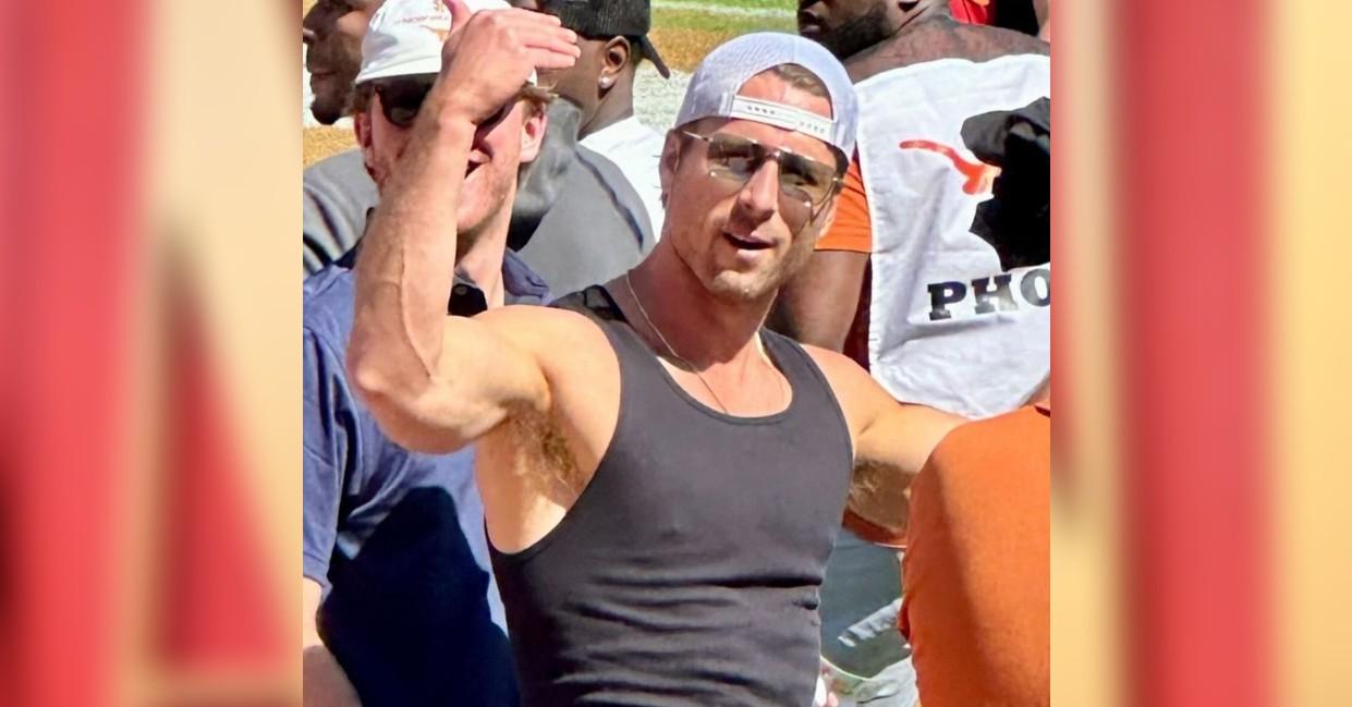 glen powell fans lose it flexing muscles university texas football game