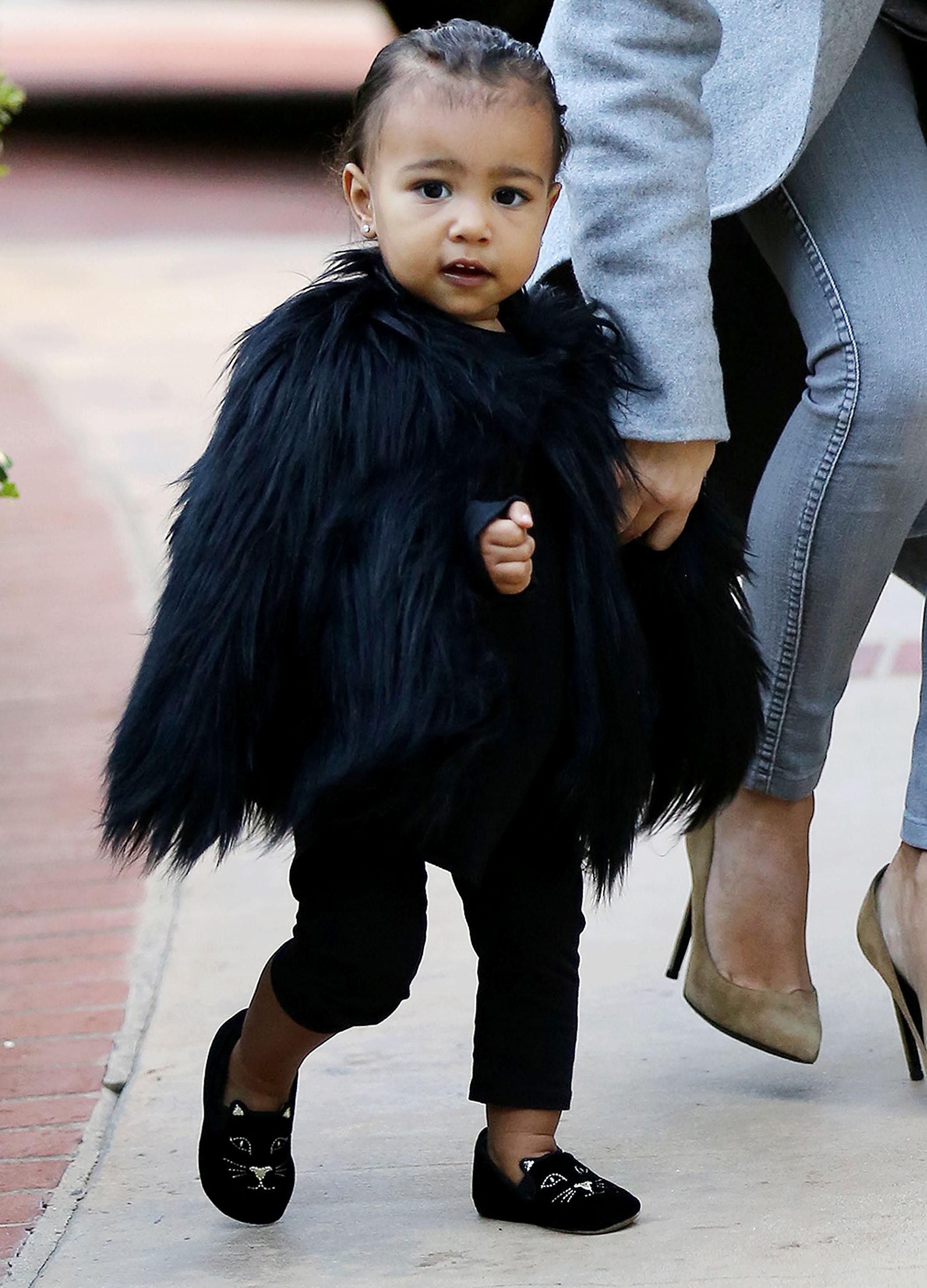 Kim Kardashian and her baby North, dressed in a black fur cape, arriving at a friend&#8217;s house in Beverly Hills ****NO DAILY MAIL SALES****