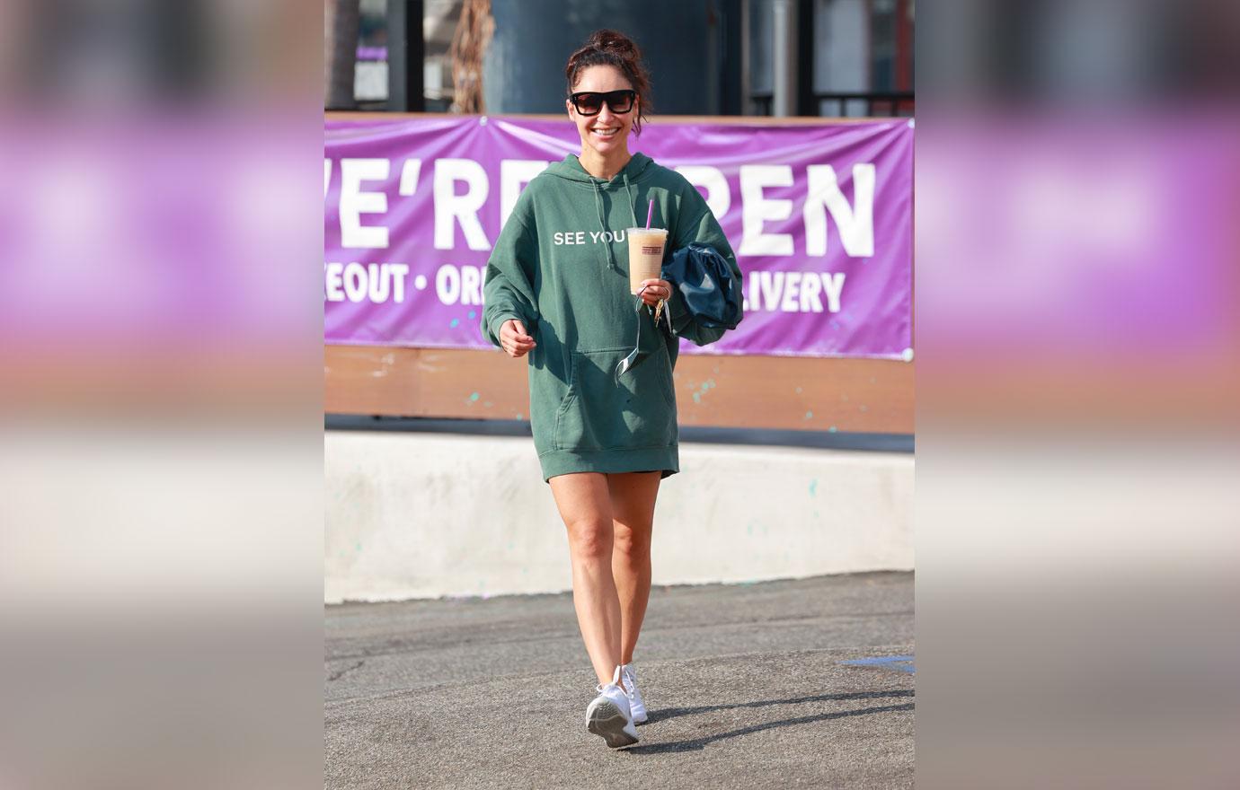 Cara Santana rocks a “see you in ‘21” Hoodie as she grabs an iced coffee after the gym. The top Made by Thirty Seconds of Mars