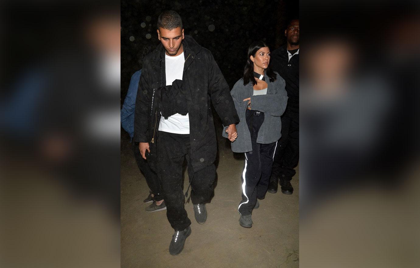 Kourtney Kardashian and Younes Bendjima hold hands at the Neon Carnival at Coachella