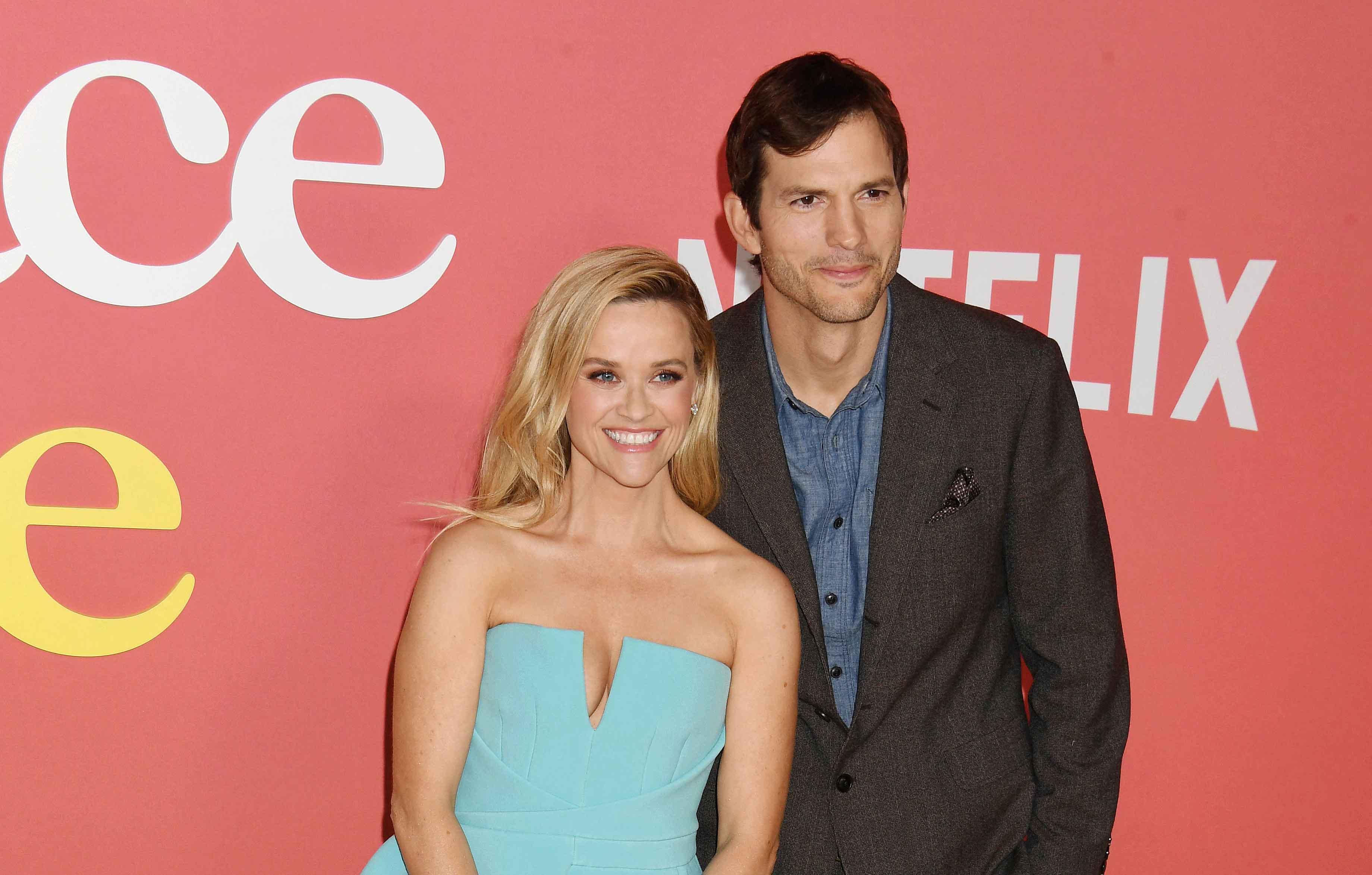 ashton kutcher attends event miami awkward reese witherspoon photos