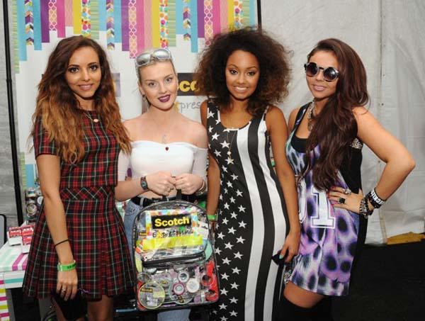 Little Mix signs a Scotch Expressions Tape decorated backpack to benefit Pencils of Promise at the Backstage Creations Celebrity Retreat At Teen Choice 2