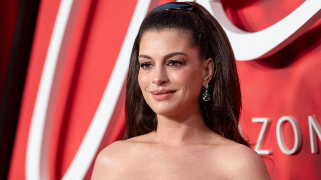 Image of Anne Hathaway poked fun at herself for taking charge at the photo call.