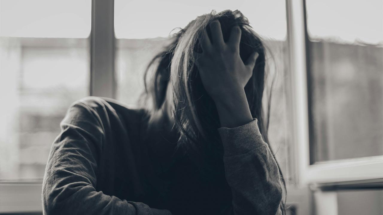 Image of woman covering face