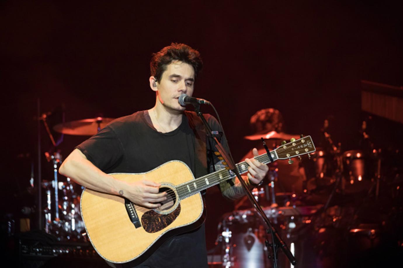 John Mayer performs on stage.