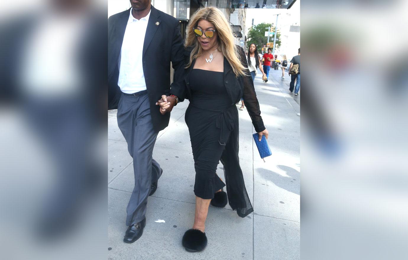 Wendy Williams Wearing Black Dress And Furry Slippers