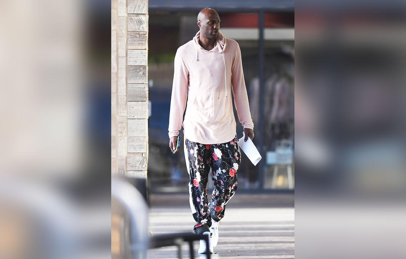 EXCLUSIVE: Lamar Odom grabs a hamburger and a vanilla shake wearing a pair of floral print parachute pants