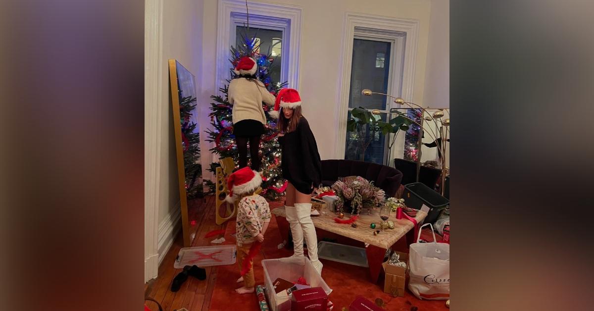 emily ratajkowski shorts boots santa hat decoarting christmas photos