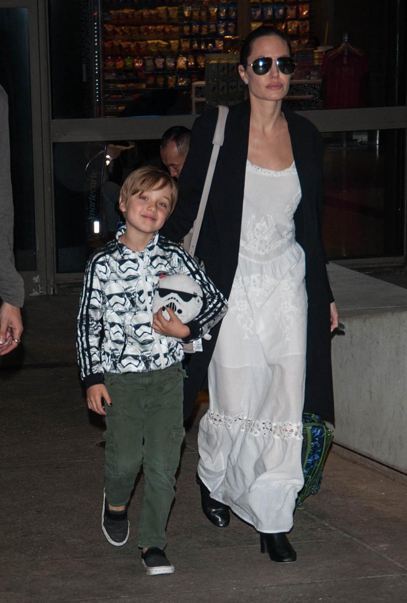 Angelina Jolie seen with brother James and son Knox wearing a Star Wars Stormtrooper jacket and carrying Plush Stormtrooper toy seen at LAX Airport