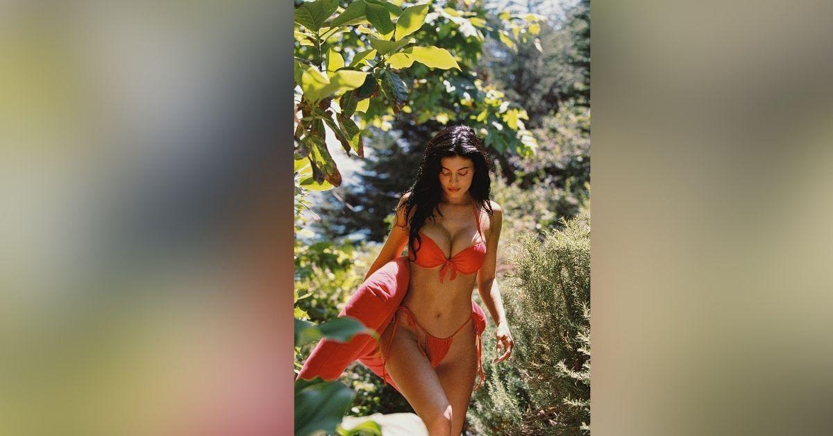 image of Kylie Jenner wore a red bikini while posing outdoors.
