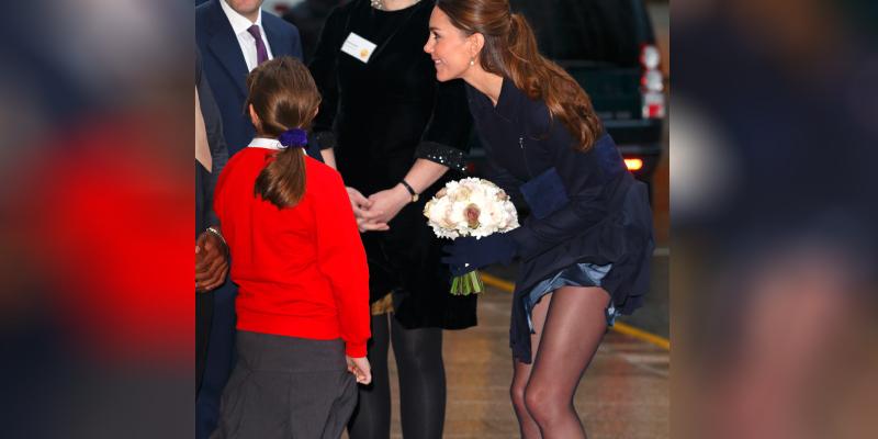 Strong winds expose Kate Middleton's nude legs at the Place2Be Forum at the offices of Clifford Chance, Canary Wharf on November 20, 2013 in London, England