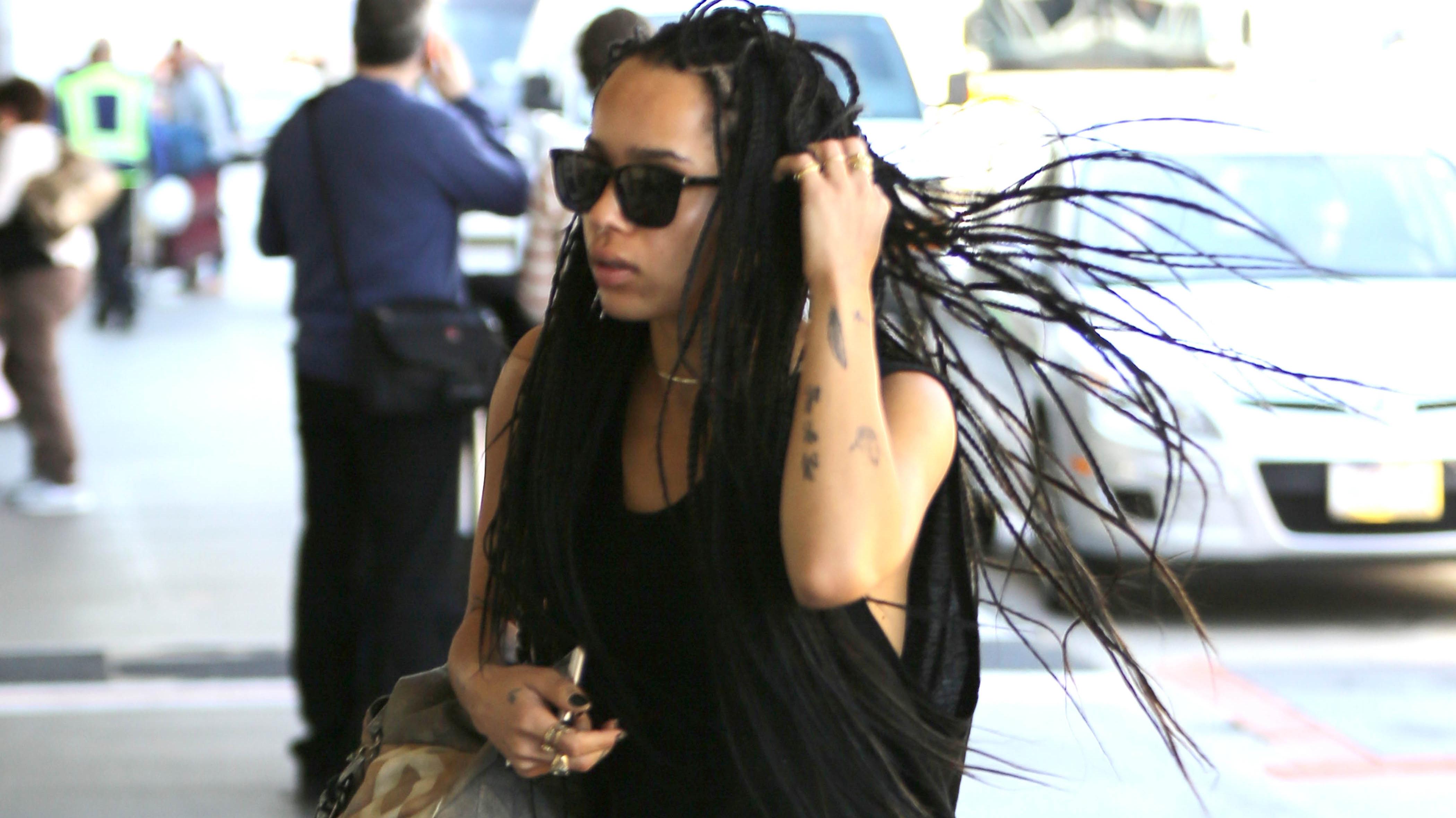 Zoe Kravitz shows that dreadlocks can be sexy as she wears a fur coat &amp; boots as she catches a flight out of Los Angeles.